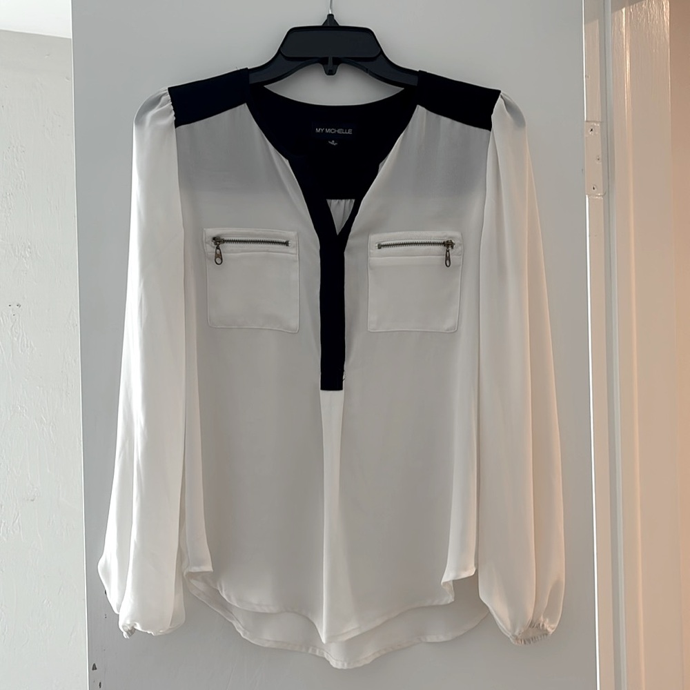Black & white top with half button front & gold zipper pockets. Transparent.